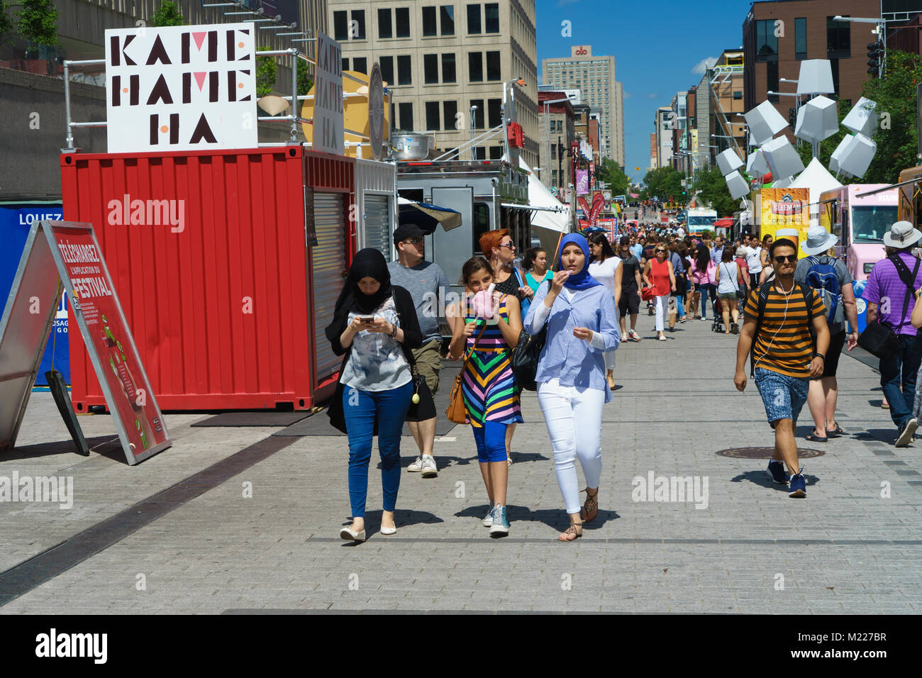 Pedestrians on a part Ste Catherine street which is closed to ...