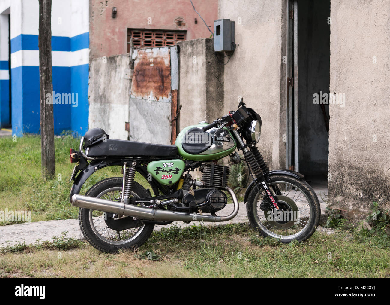 Las Tunas, Cuba - September 4, 2017: An MZ TS 250 Motorcycle parked in front of the entrance of a residential building. Stock Photo