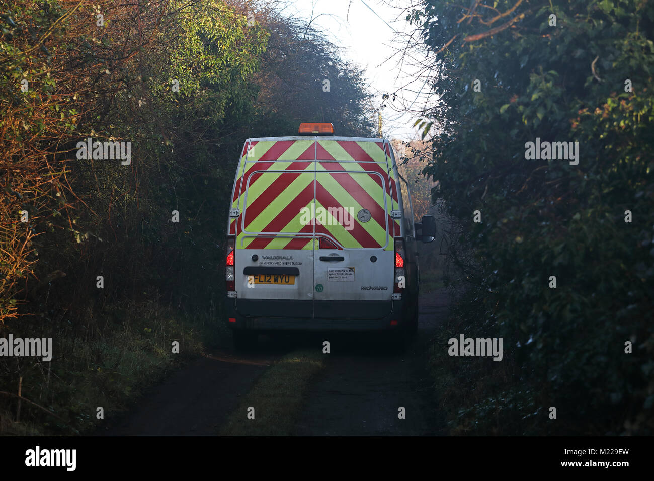 emergency services van on narrow overgrown lane  Eccles-on-Sea, Norfolk, UK         January Stock Photo