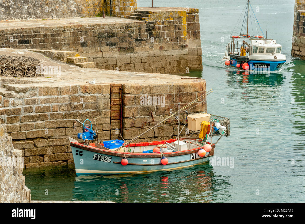 CHARLESTOWN, CORNWALL, UK - JUNE 07, 2009:  Small traditional fishing boat tied up in the harbour Stock Photo