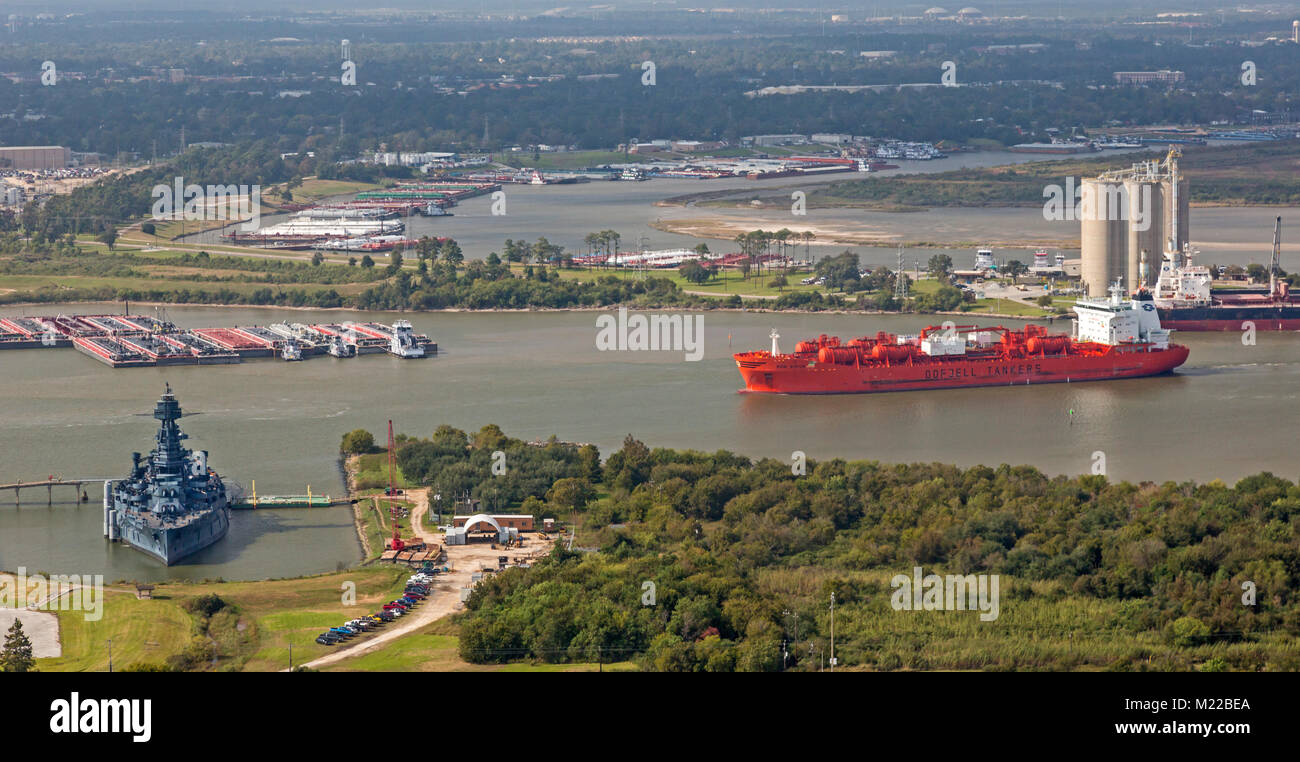 Houston, Texas - The Bow Sirius, a Norwegian oil/chemical tanker, in the Houston Ship Channel. Docked at left is the Battleship Texas, retired in 1946 Stock Photo