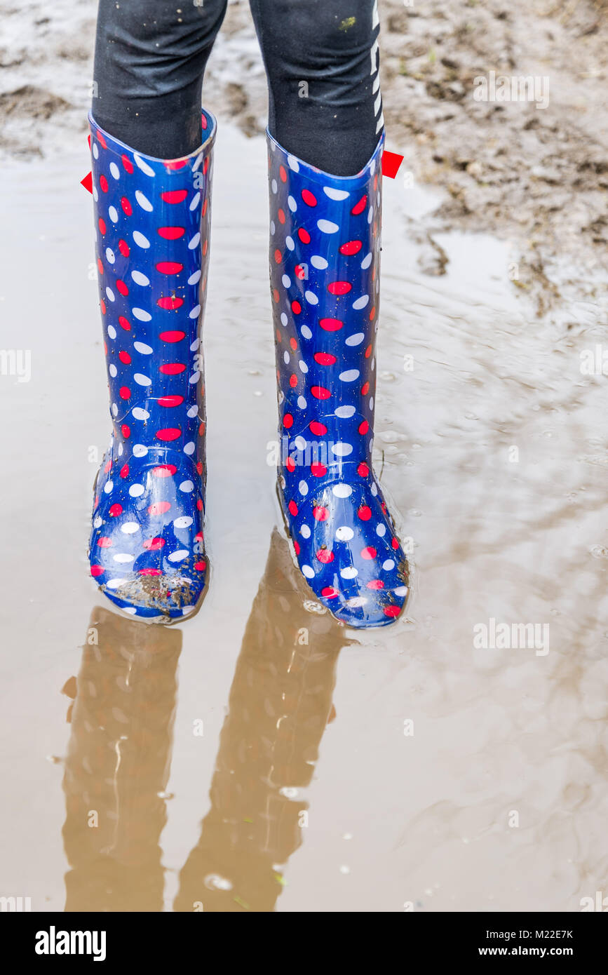 Childs colouful muddy wellington boots in a puddle Stock Photo - Alamy