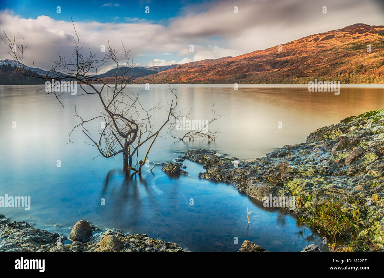 A long exposure shot looking west from the southern shore of Loch Venachar, in the Trossachs, Scotland Stock Photo