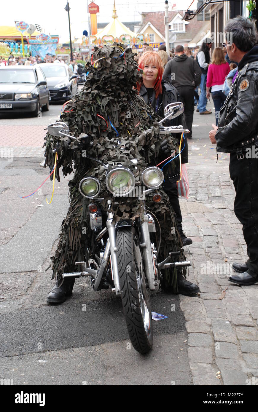 A man in a leaf costume sits on a motorbike during the May Day Jack In The Green festival and separate motorbike rally at Hastings, UK on May 5, 2009. Stock Photo