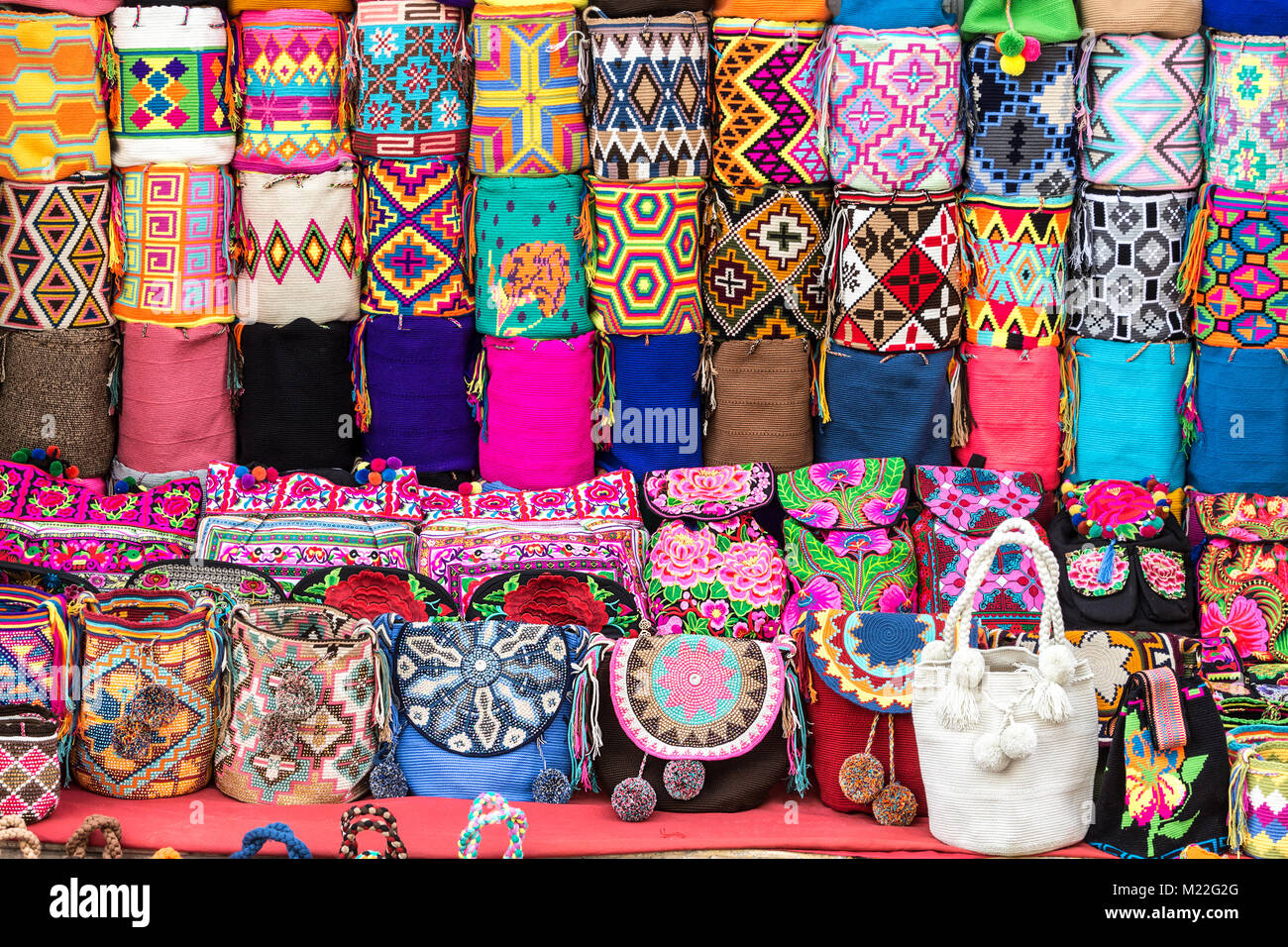 Multicolor knitted backpacks Mochilas Wayúu and bags made by Wayúu natives  on the street of the old colonial town in Cartagena, Colombia Stock Photo -  Alamy