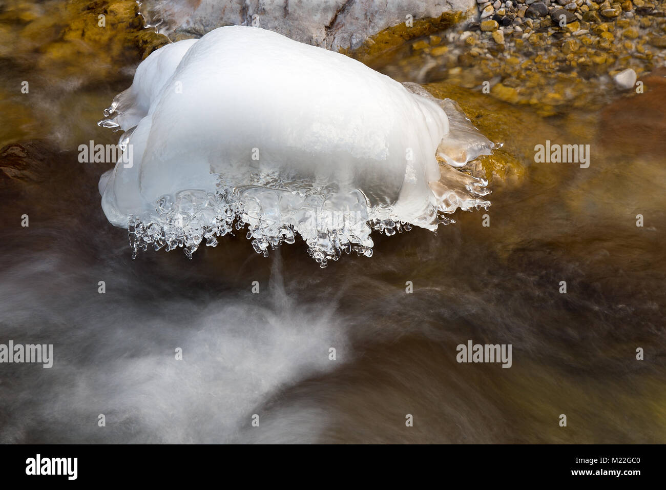 Ice on frozen rocks on River in winter Stock Photo - Alamy