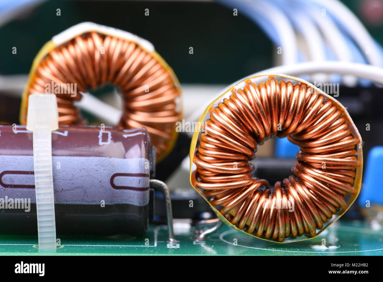 Inductor copper coil on circuit board Stock Photo
