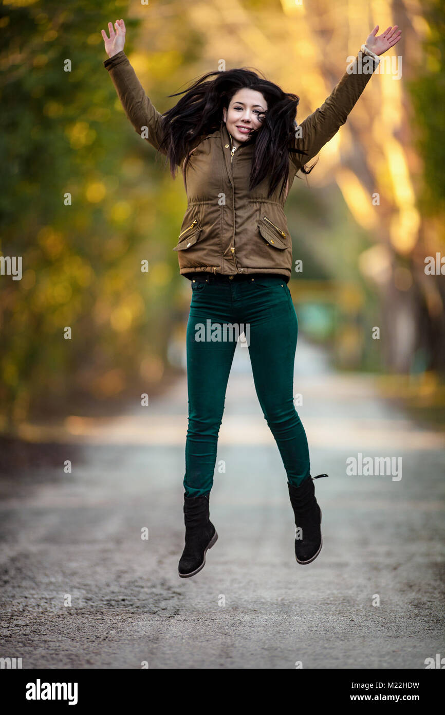 Latina Teenage Girl In Black Leggings, Top And Jacket Posing On