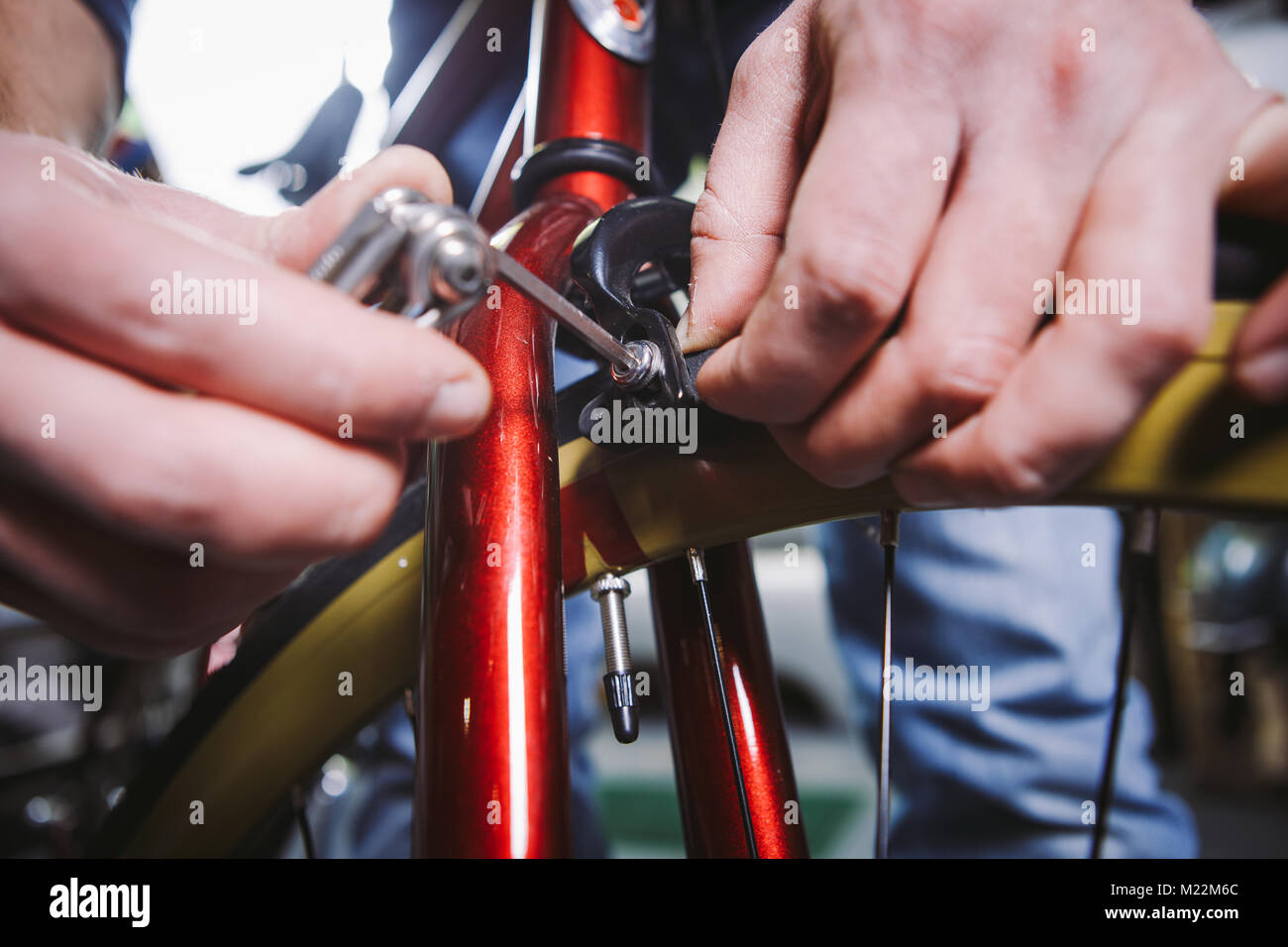 Theme repair bikes. Closeup of a Caucasian man's hand use a hand tool