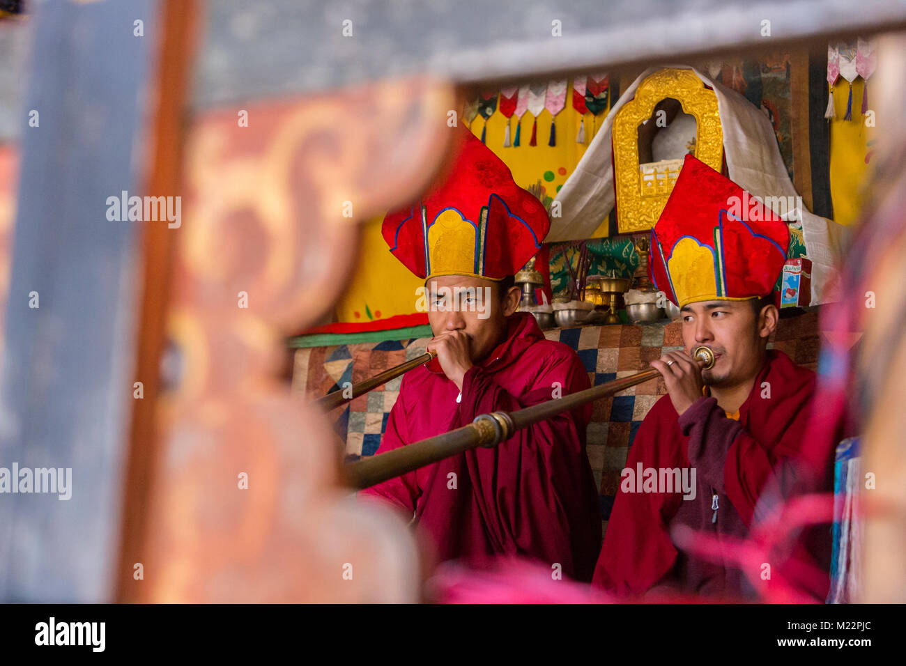 Prakhar Lhakhang, Bumthang, Bhutan.  Two Buddhist Monks Playing Dungchen, the Long Tibetan Trumpet. Stock Photo