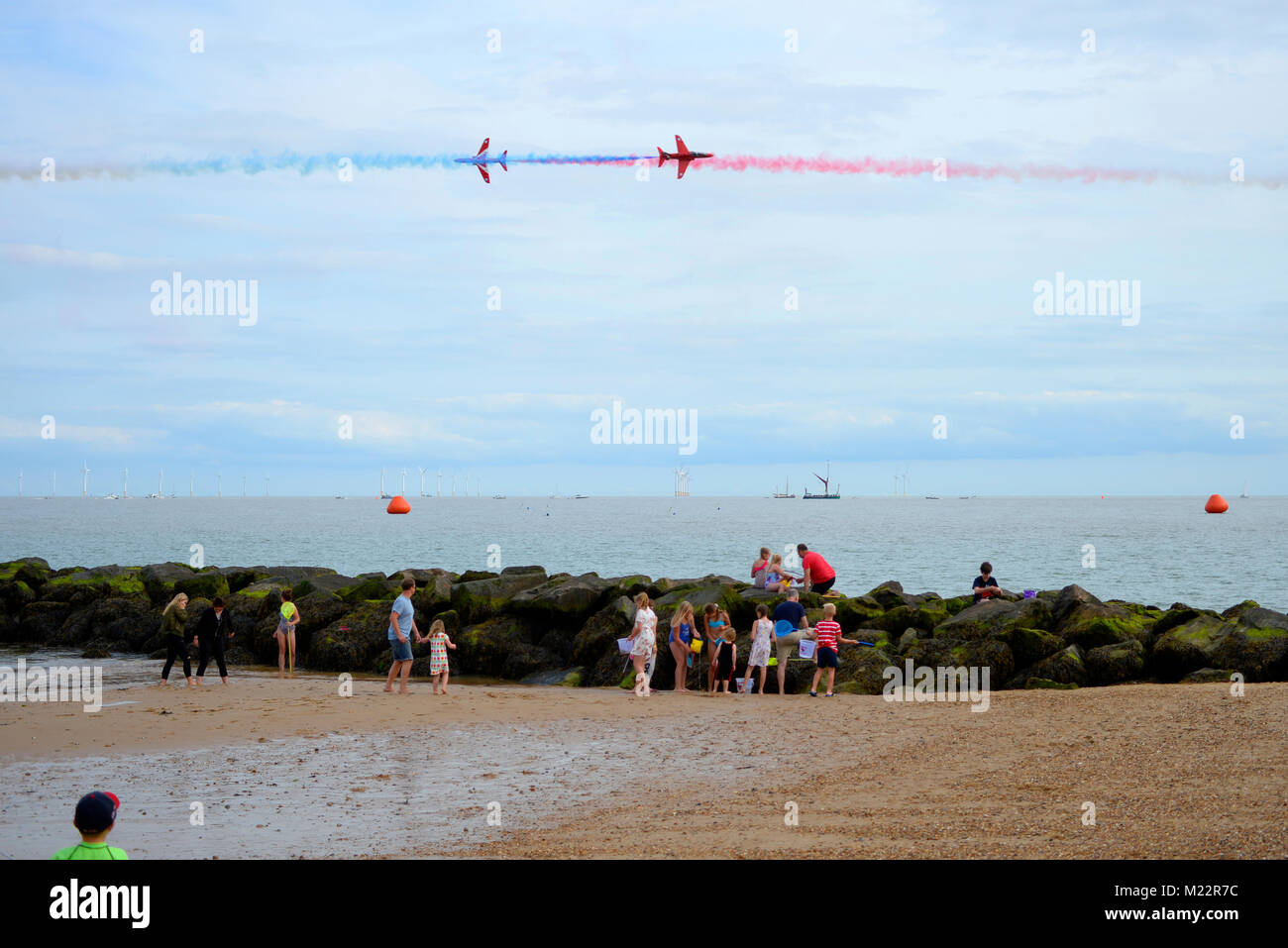 RAF Red Arrows at the Clacton on sea Airshow. People watching them flying over the sea Stock Photo