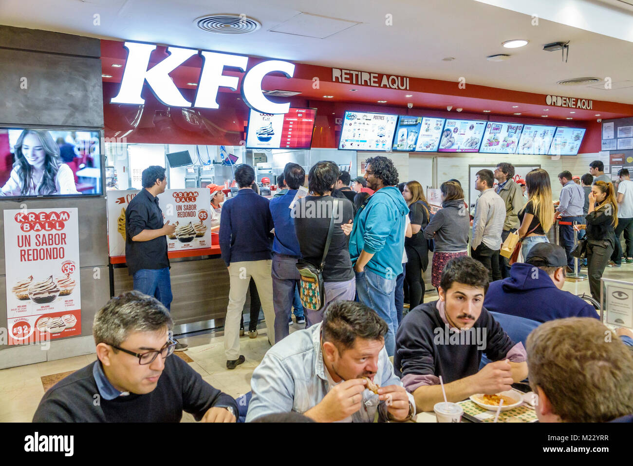 Buenos Aires Argentina,Galerias Pacifico mall,food court plaza,KFC,American chicken restaurant,counter,fast food,line,Hispanic,man men male,eating,Arg Stock Photo