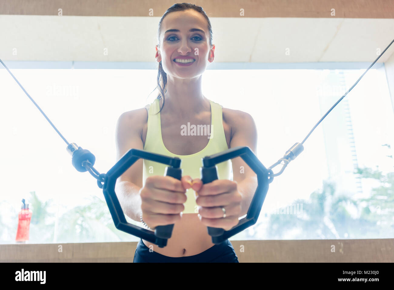 Low-angle view portrait of a cheerful beautiful woman exercising Stock Photo