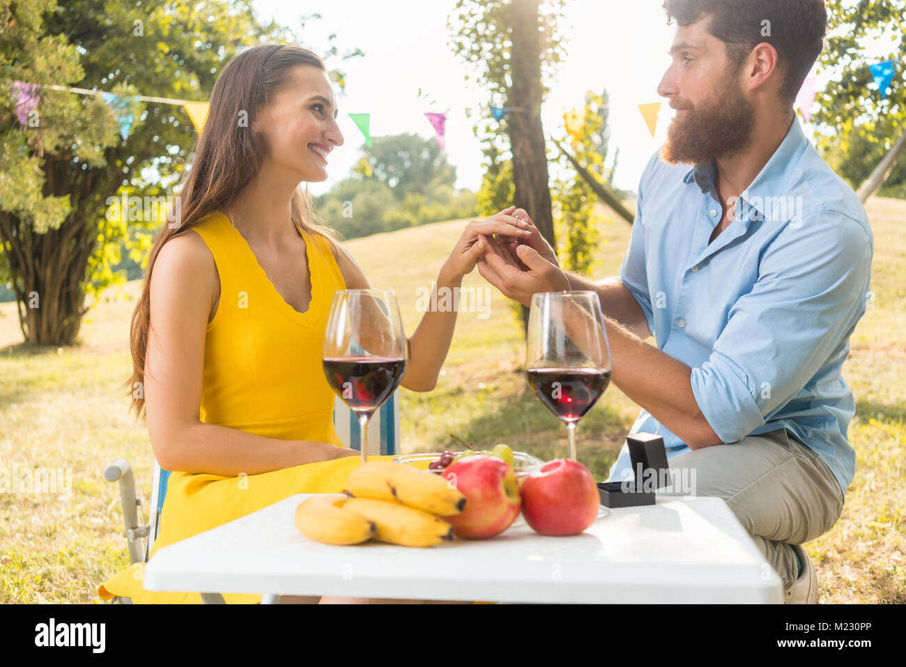 Young man showing to beautiful girlfriend an engagement ring Stock Photo Alamy