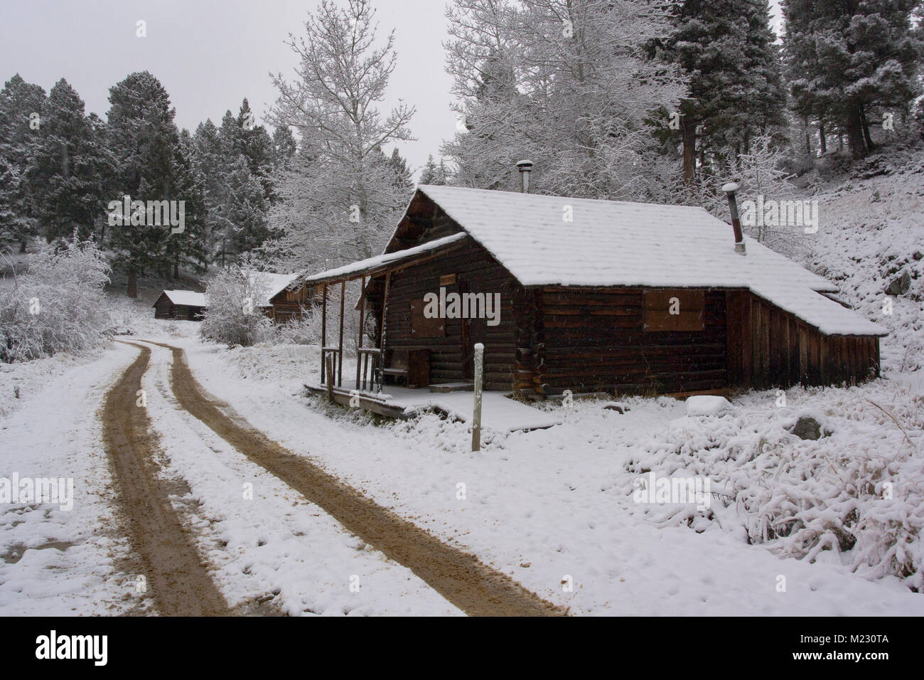Snow covered wooden cabins at the Ghost Town, on Bear Gulch
