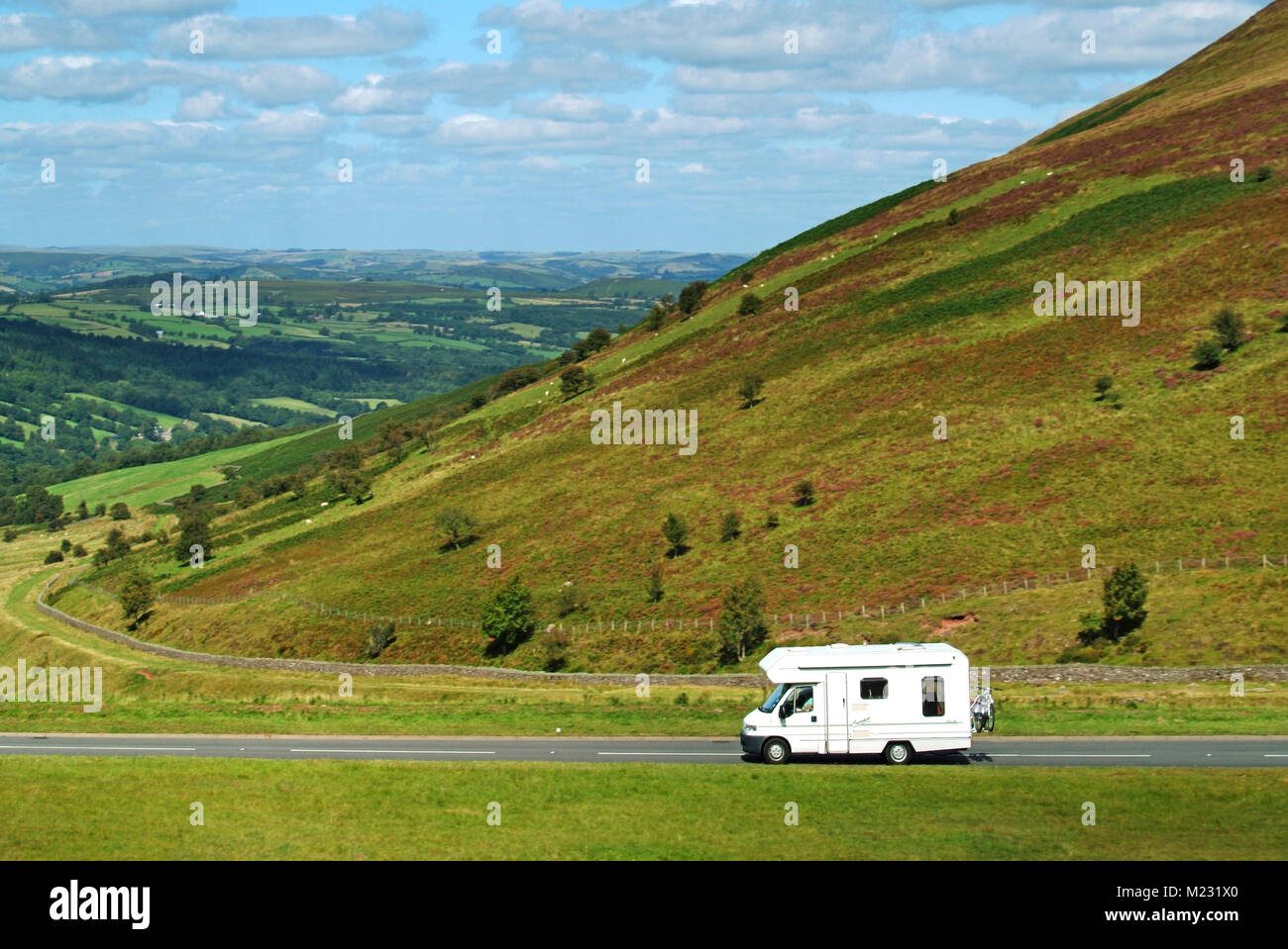 Camper van & bike rack scenic drive on A470 road Brecon Beacons National Park passing head of Tarell Valley scenic landscape in Powys South Wales UK Stock Photo