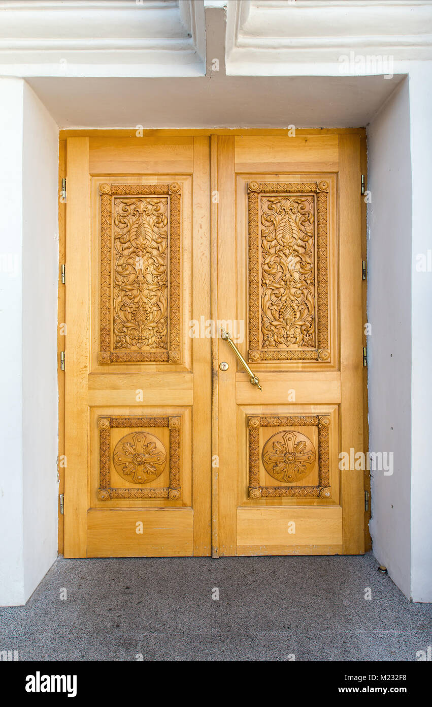 yellow wooden doors with carvings Stock Photo Alamy