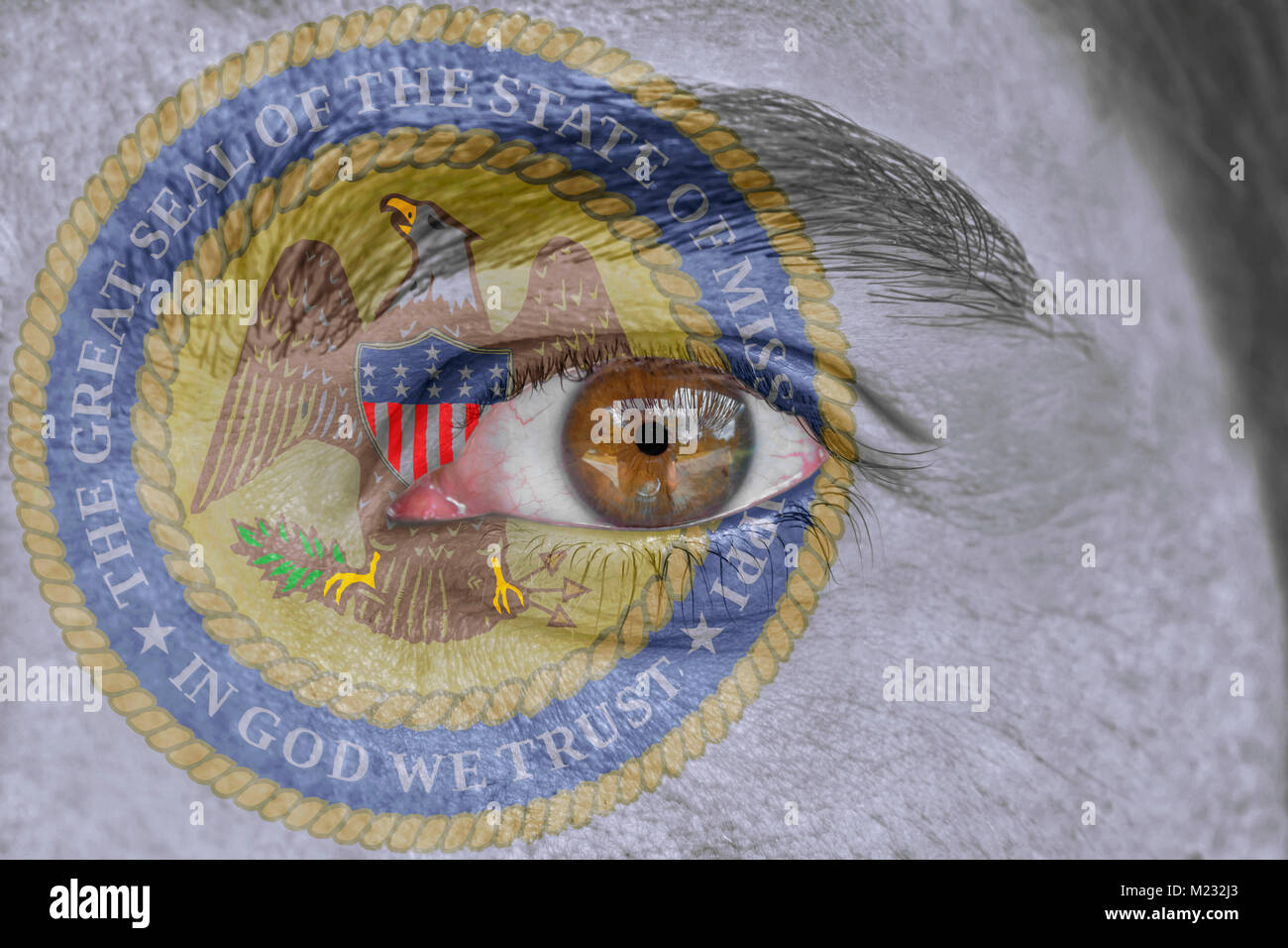 Human face and eye painted with US state seal flag of Mississippi Stock Photo