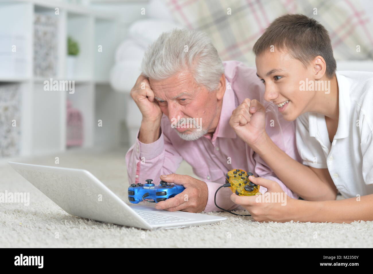 grandfather and grandson playing computer games  Stock Photo