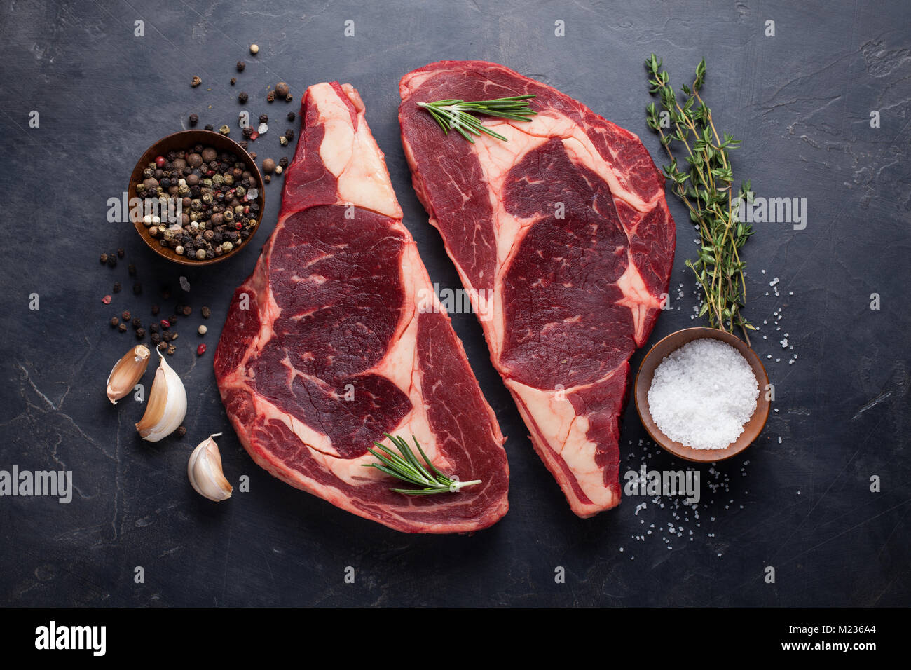 Raw fresh marbled meat Steak Ribeye Black Angus on black marble ...