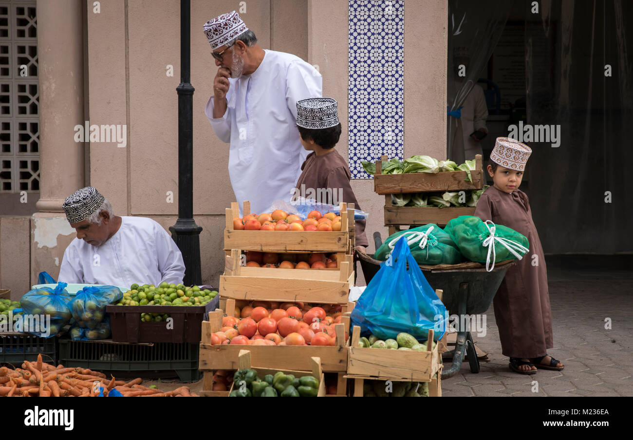 nizwa, Oman, Febrary 2nd, 2018: omani kid at a vegetable market Stock Photo