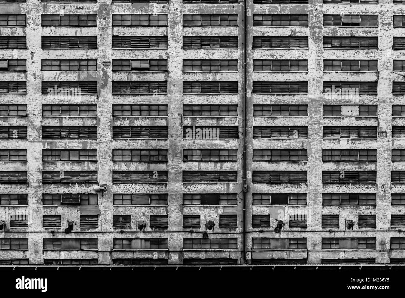 Gdansk shipyard, Poland. Retro style black and white. Cranes, old shipyard buildings, rusty structures. Stock Photo