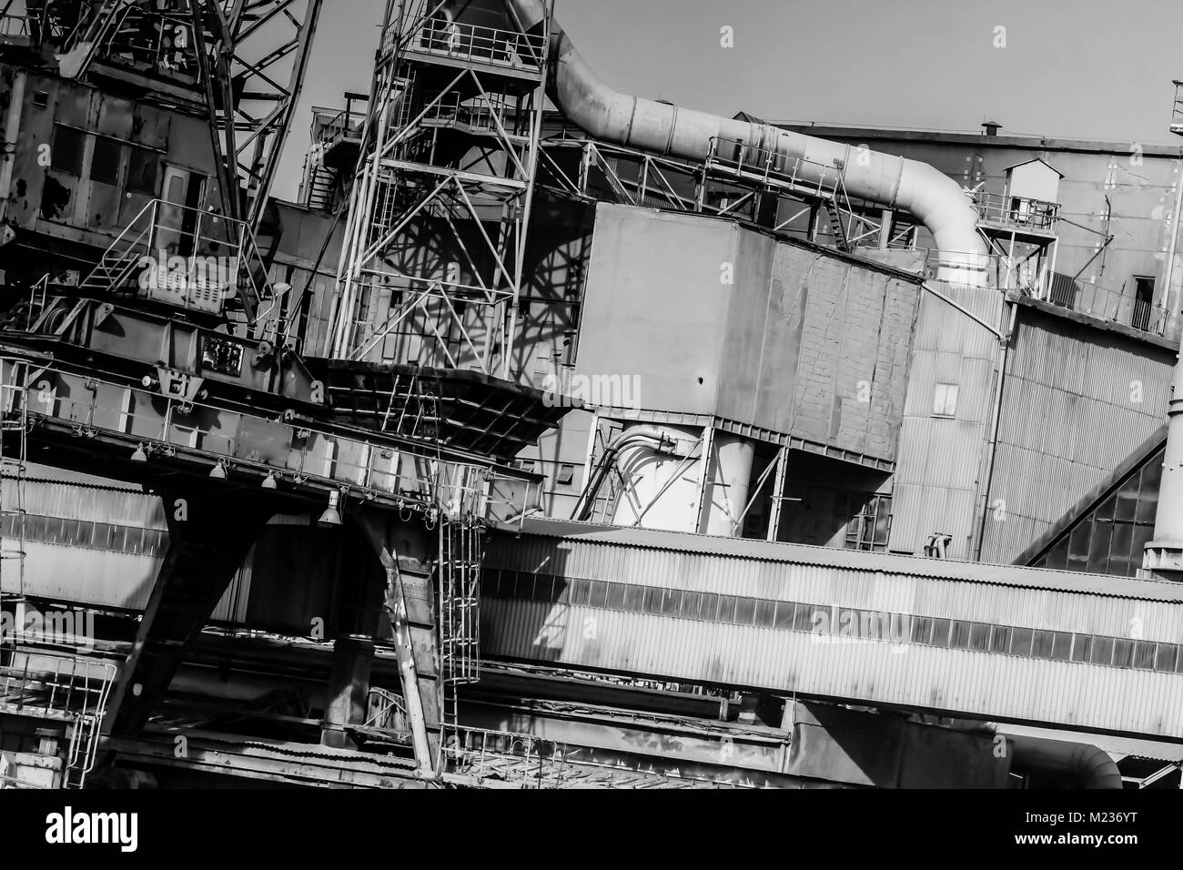 Gdansk shipyard, Poland. Retro style black and white. Cranes, old shipyard buildings, rusty structures. Stock Photo
