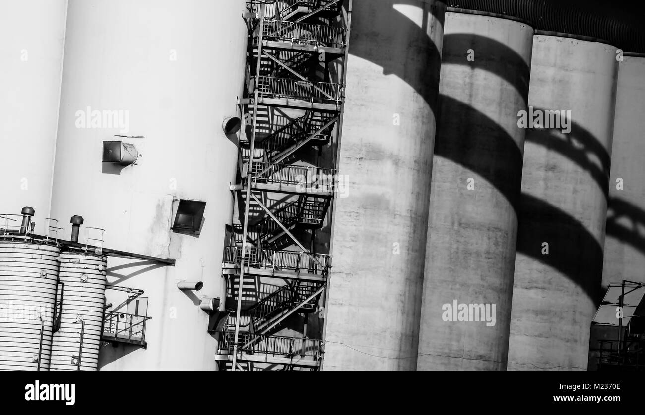 Gdansk shipyard, Poland. Retro style black and white. Cranes, old shipyard buildings, rusty structures. Stock Photo