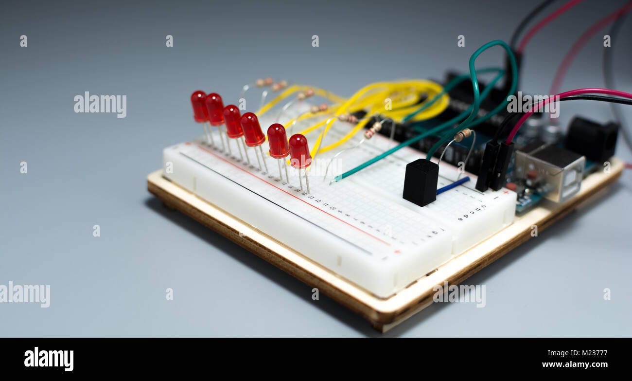 Array of red LEDs on a breadbord connected to a microcontroller Stock Photo