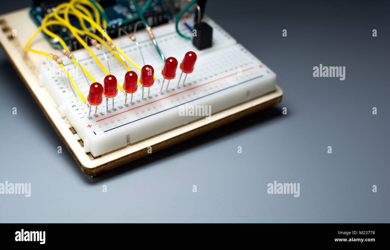 Array of red LEDs on a breadbord connected to a microcontroller Stock Photo