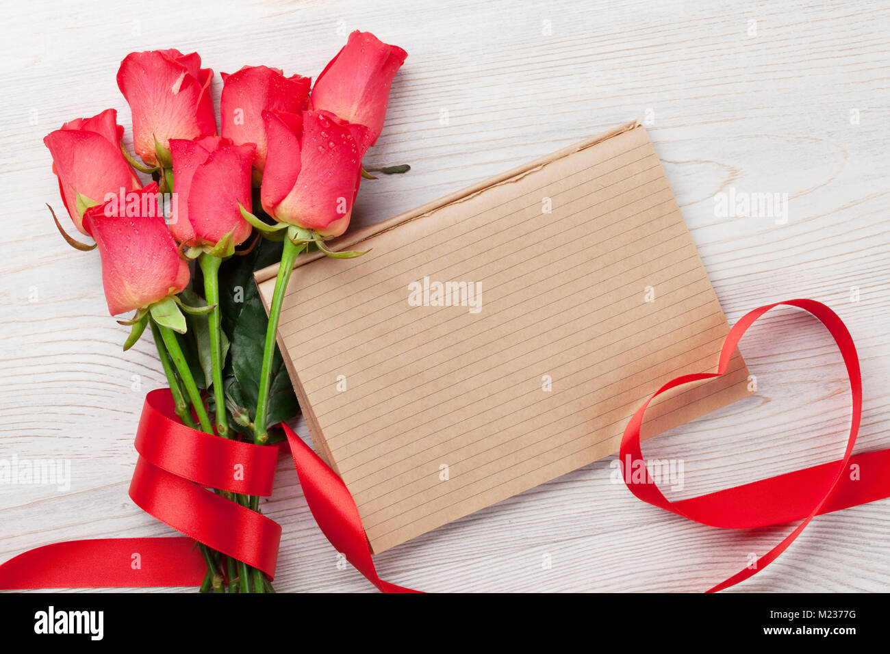 Valentines day greeting card with red roses and heart shaped ribbon on ...