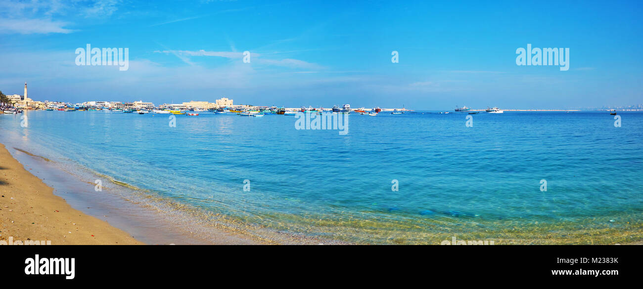 Panorama of the sand beach, stretching along Corniche avenue with a view on the fishing boats in Eastern port and Qaitbay Citadel on background, Alexa Stock Photo