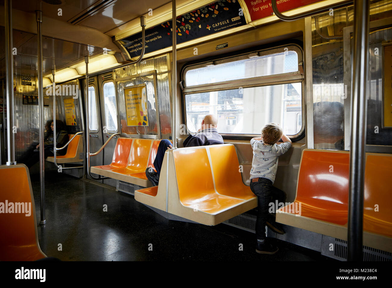 New York city in Manhattan, young boy looking out of the window of a subway train Stock Photo