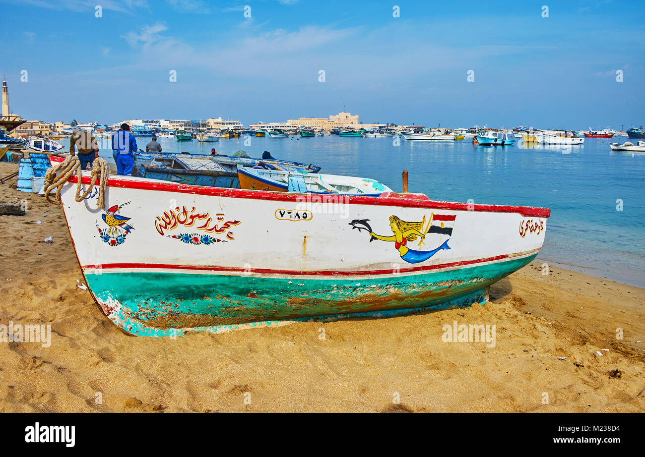 ALEXANDRIA, EGYPT - DECEMBER 17, 2017:  The walk along the Eastern Harbor with a view on old fishing boats, docked at the shore or standing on the san Stock Photo