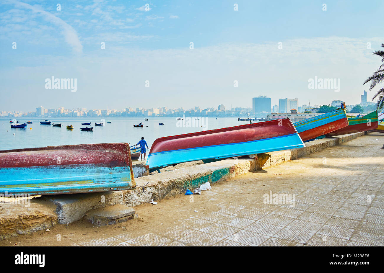 The row of upside down boats along the Eastern Harbor at Corniche promenade of Alexandria, Egypt. Stock Photo