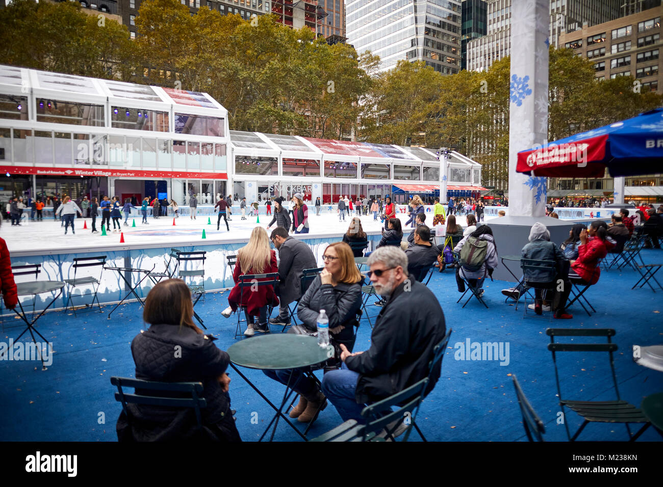 New York City Midtown Manhattan Ice rink in privately managed public park  Bryant Park Stock Photo