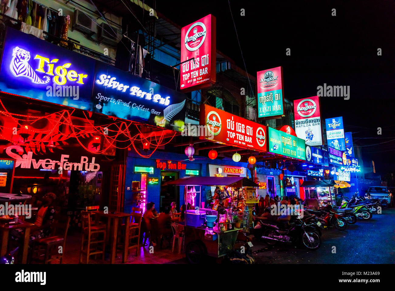 Colourful illuminated neon signs at night outside bars in the red light