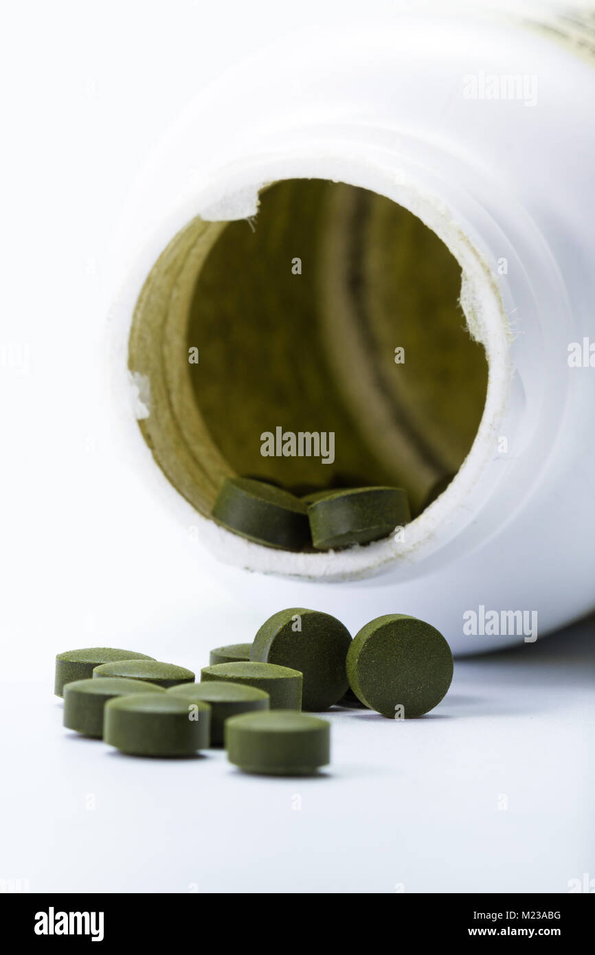 close up of a group of fermented chlorella tablets isolated on a white