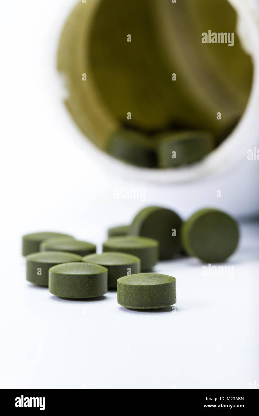close up of a group of fermented chlorella tablets isolated on a white