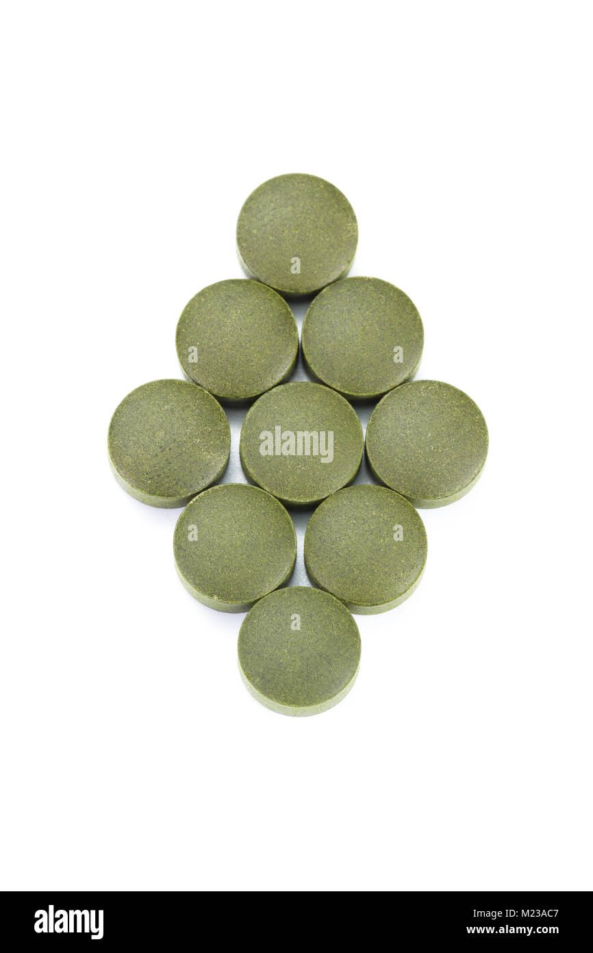 close up of a group of fermented chlorella tablets isolated on a white