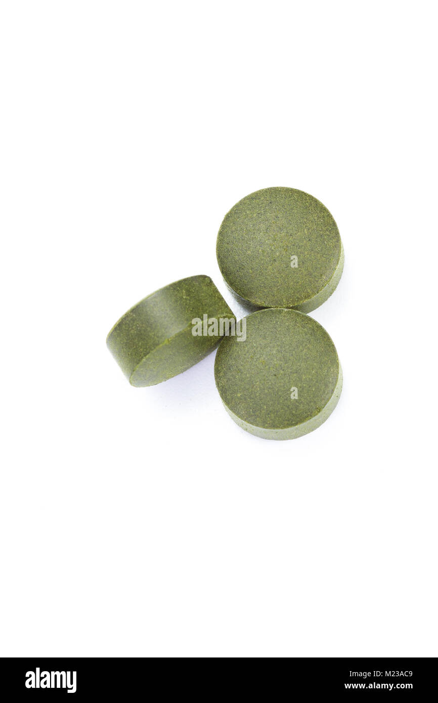 close up of a group of fermented chlorella tablets isolated on a white