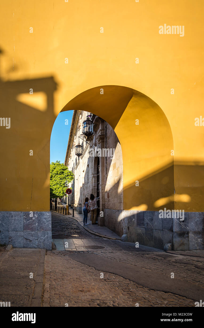 Cordoba, Spain - April 10, 2017: Arch in yellow wall in Caballerizas Reales Street in Cordoba Stock Photo