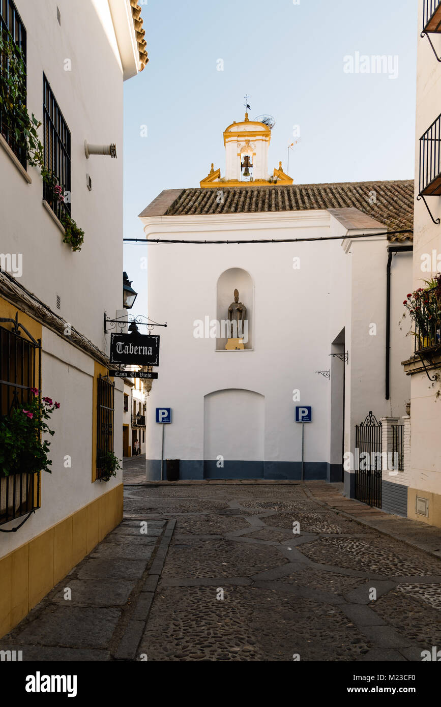 Cordoba, Spain - April 10, 2017: Old typical street in the Alcazar Viejo quarter of Cordoba near San Basilio Church. This quarter is famous for his de Stock Photo