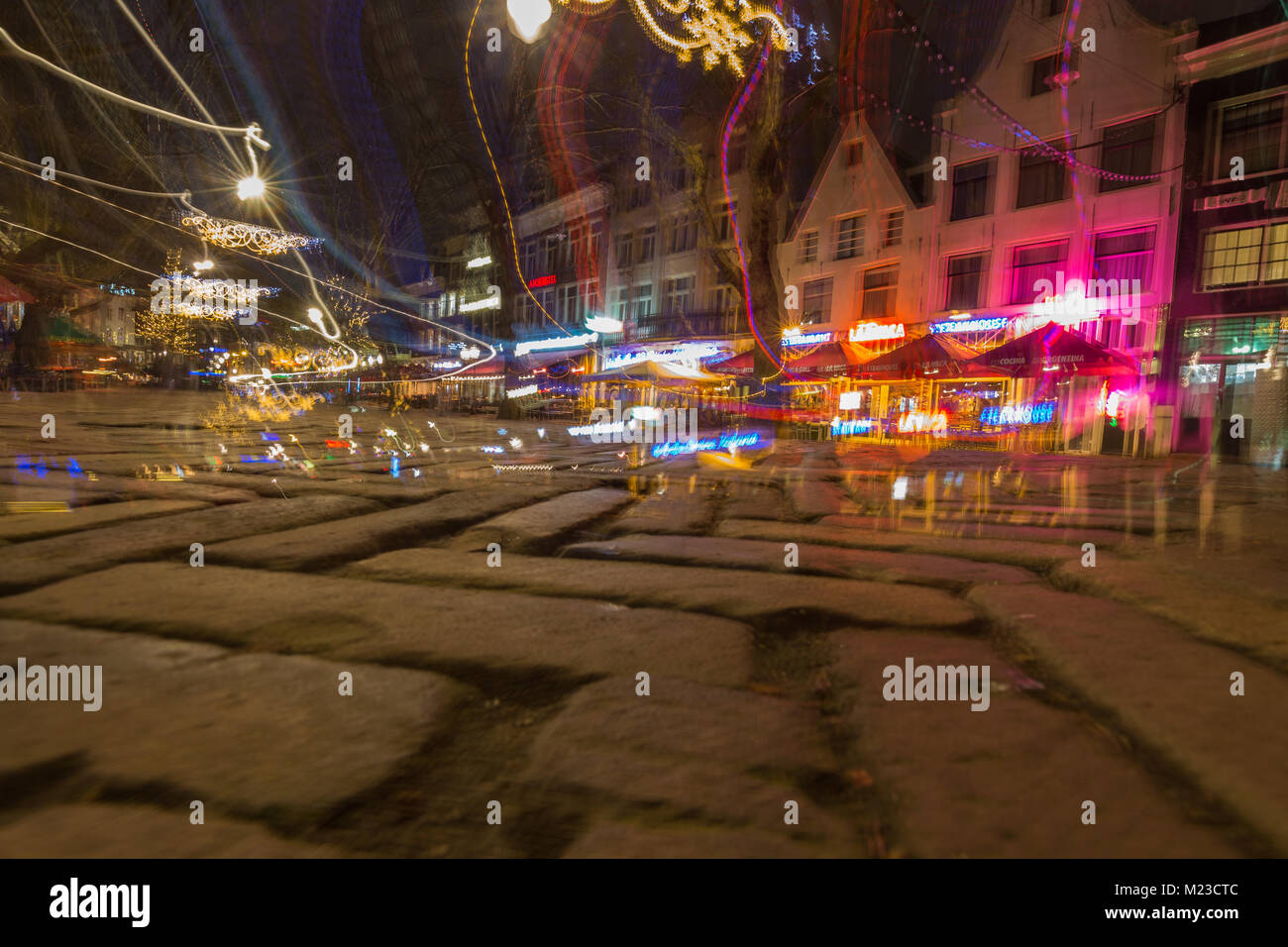 Impression of a drunk's night out in Amsterdam. Blurred neon signs with double vision, fallen down on pavement. Stock Photo
