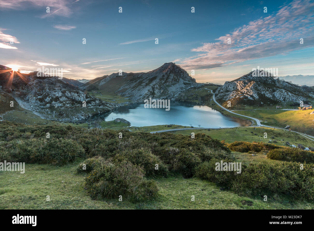 spectacular and colorful sunset in the lakes of Covadonga, Asturias, on a very cold winter day, where you can see the beautiful colors of the clouds, Stock Photo