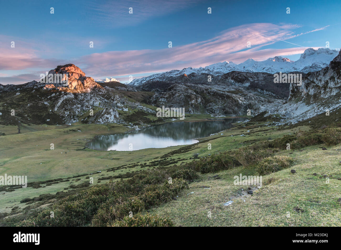 spectacular and colorful sunset in the lakes of Covadonga, Asturias, on a very cold winter day, where you can see the beautiful colors of the clouds, Stock Photo