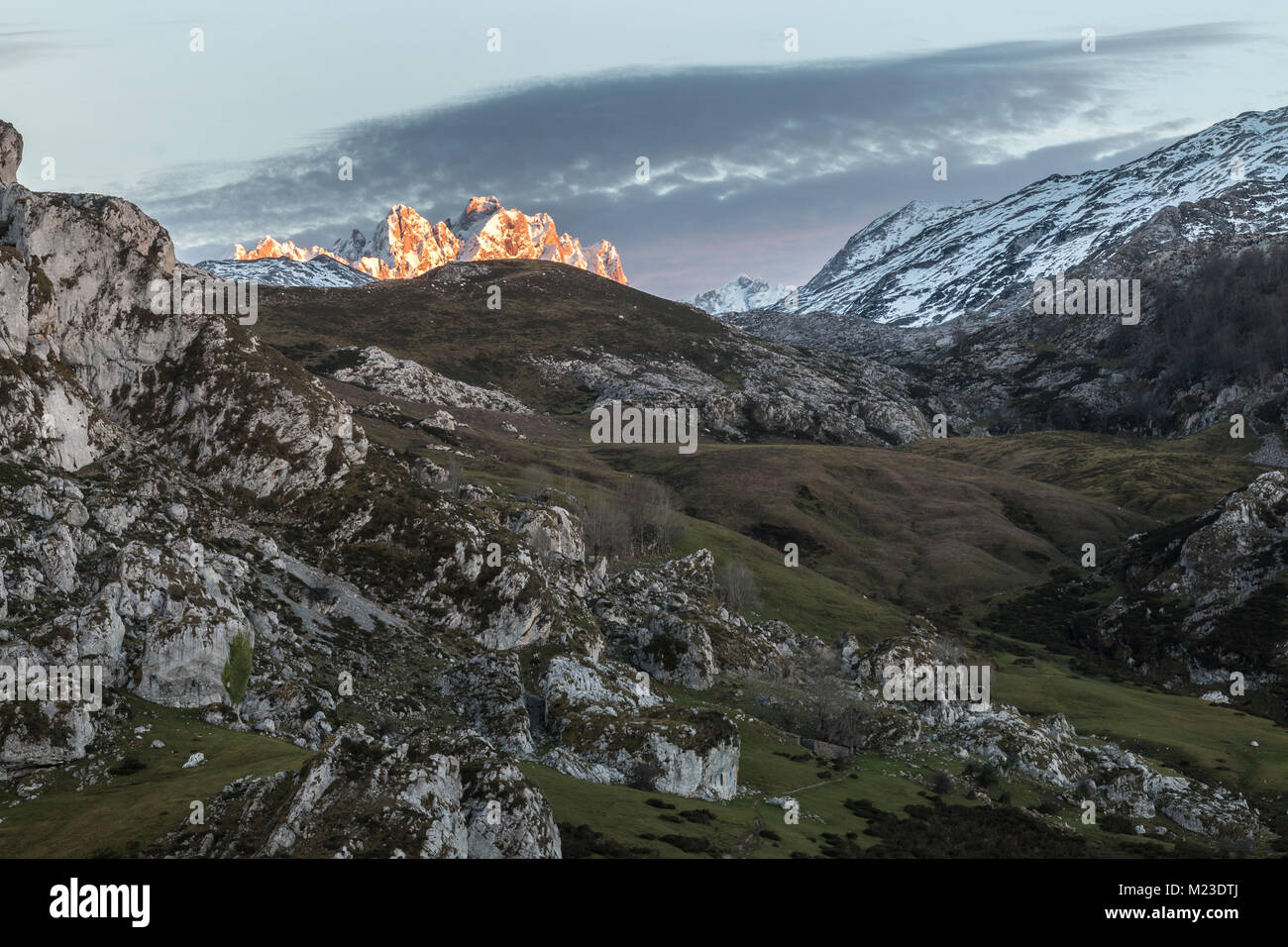 spectacular and colorful sunset in the lakes of Covadonga, Asturias, on a very cold winter day, where you can see the beautiful colors of the clouds, Stock Photo