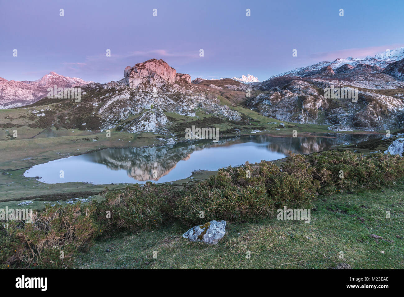 spectacular and colorful sunset in the lakes of Covadonga, Asturias, on a very cold winter day, where you can see the beautiful colors of the clouds, Stock Photo