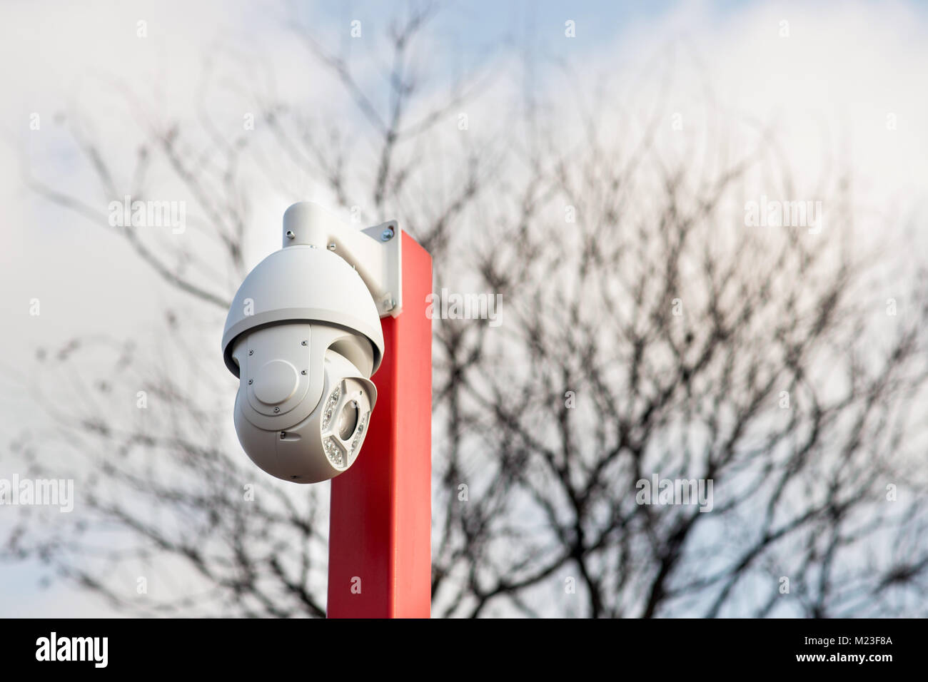 Modern white security camera for surveillance and monitoring located outside Stock Photo