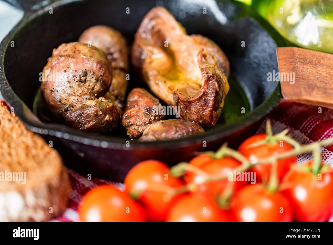 Tasty roasted chicken giblets in pan and rye bread Stock Photo Alamy
